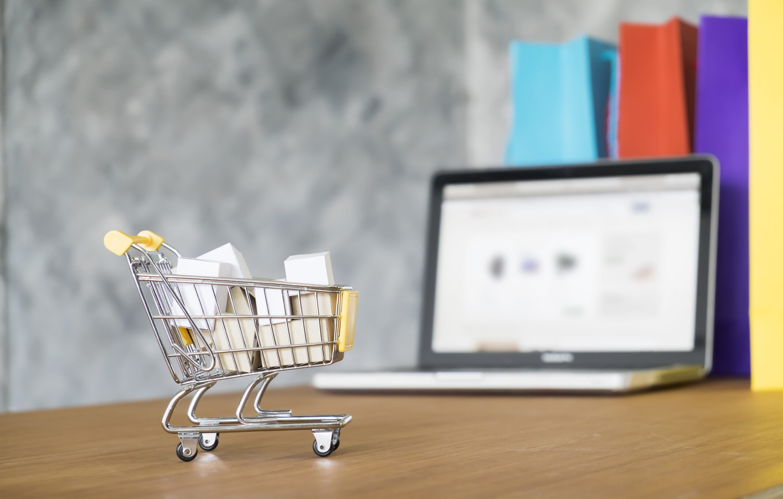 The image of eCommerce cart along with the laptop